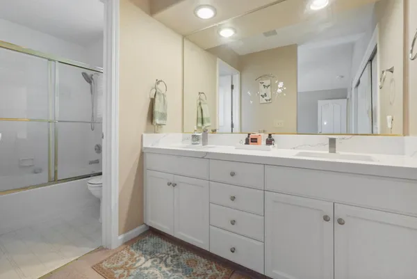 a bathroom with a sink double vanity and a mirror