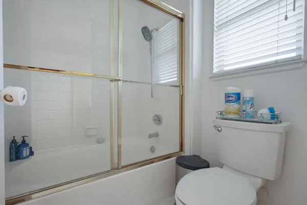 a bathroom with a toilet and a shower