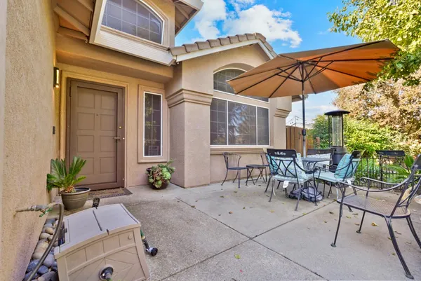 a patio with a patio table and chairs