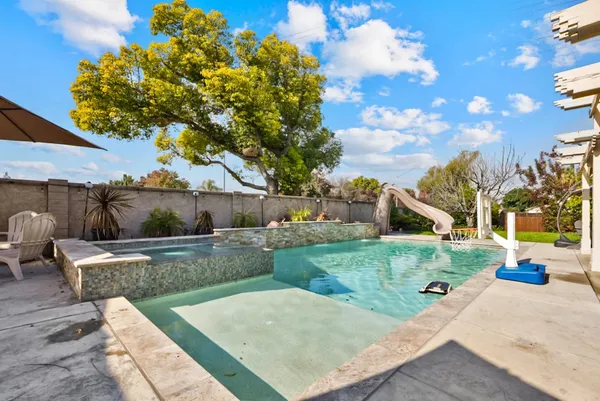 a view of backyard with outdoor seating and green space