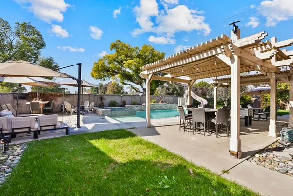 a view of a backyard with sitting area