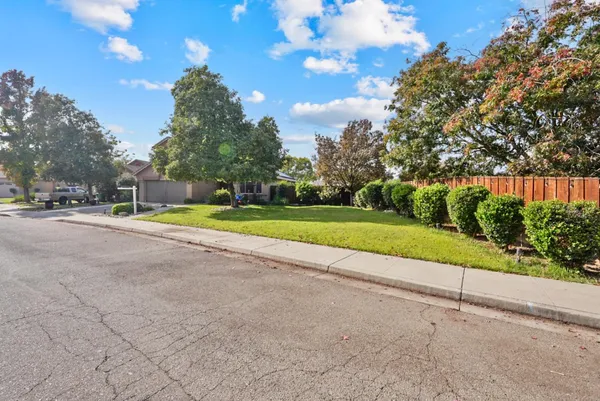 a view of a road with a houses in the background