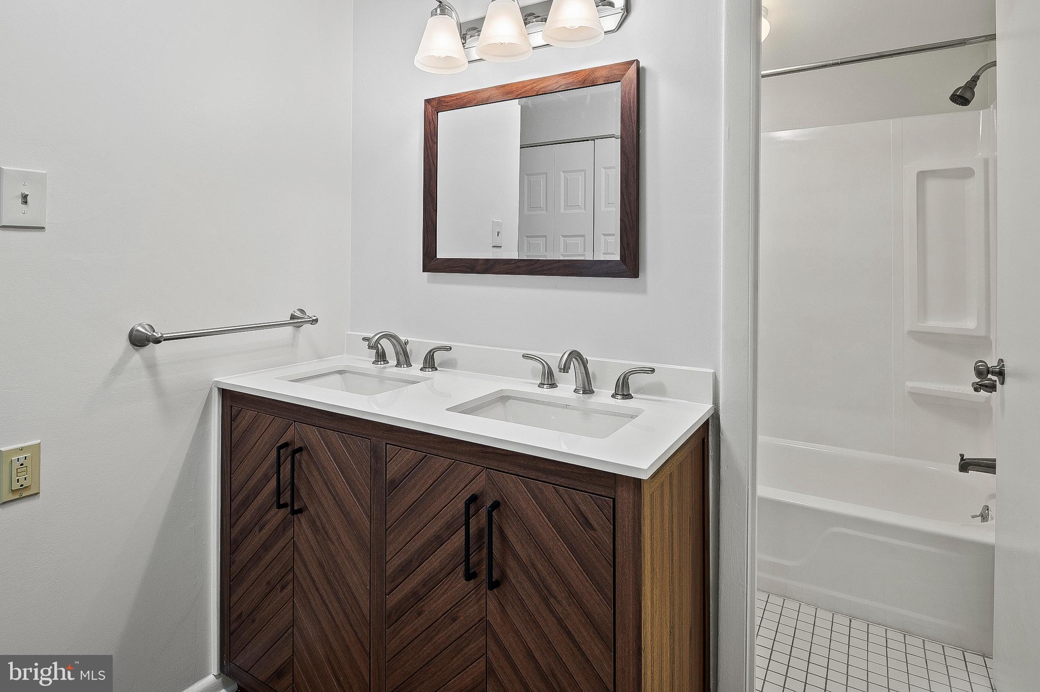 5232 West Running Brook Road, Unit 101 Columbia, MD 21044 - Photo 17 of 39 a bathroom with a sink and a mirror