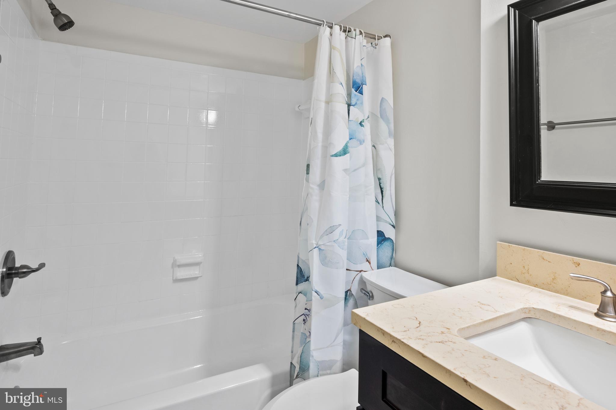 5232 West Running Brook Road, Unit 101 Columbia, MD 21044 - Photo 23 of 39 a bathroom with a granite countertop sink toilet and shower