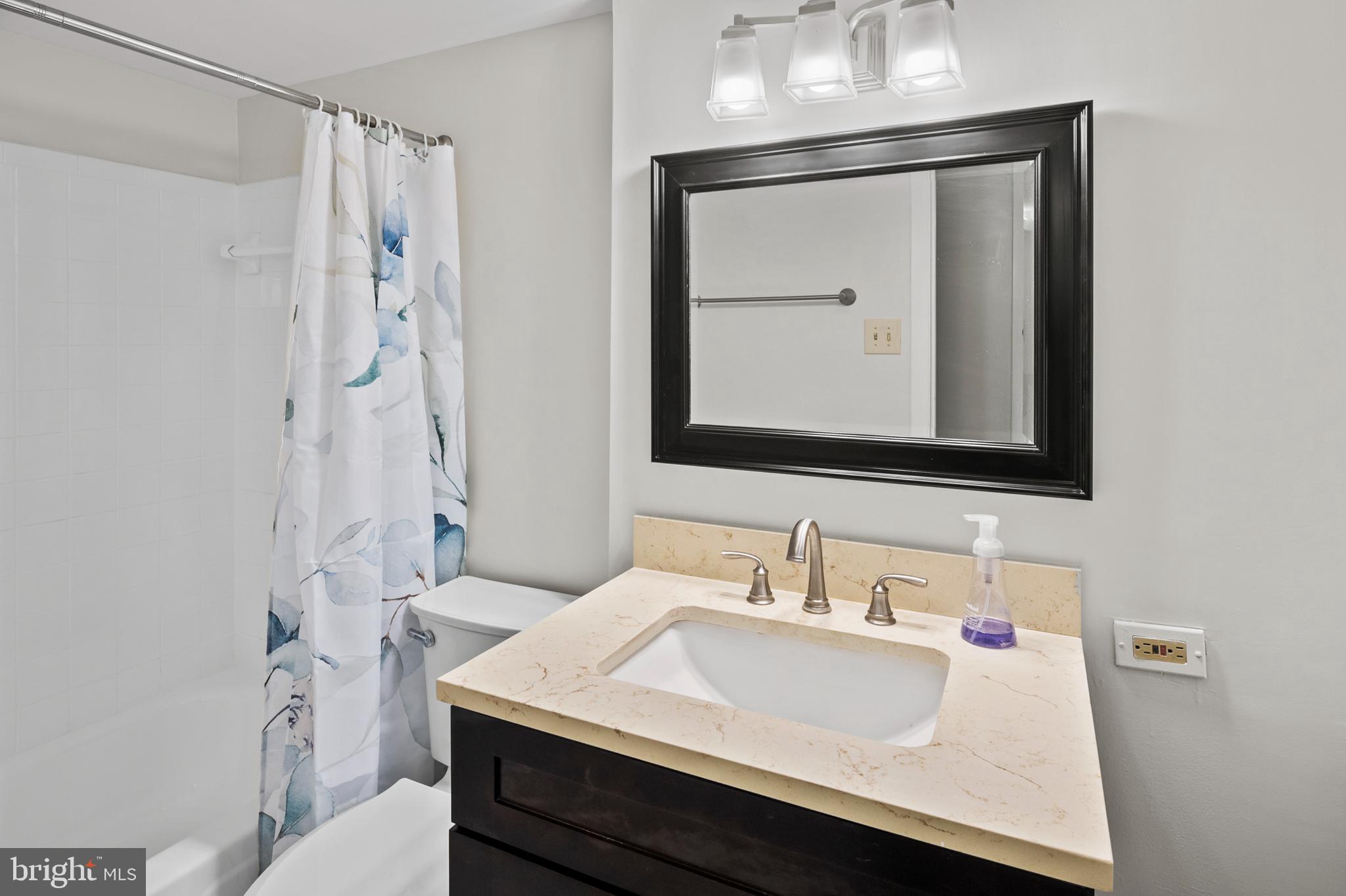 5232 West Running Brook Road, Unit 101 Columbia, MD 21044 - Photo 24 of 39 a bathroom with a sink vanity and a mirror