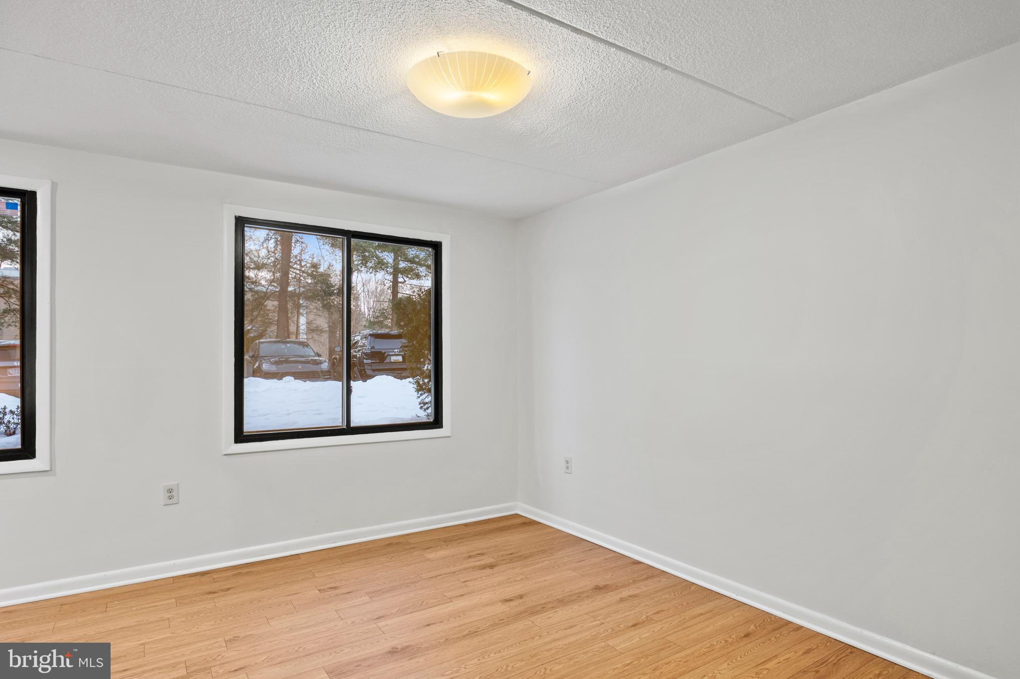 5232 West Running Brook Road, Unit 101 Columbia, MD 21044 - Photo 7 of 39 an empty room with wooden floor and windows