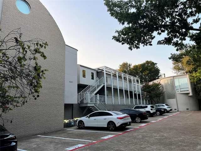 a view of cars parked in front of a house