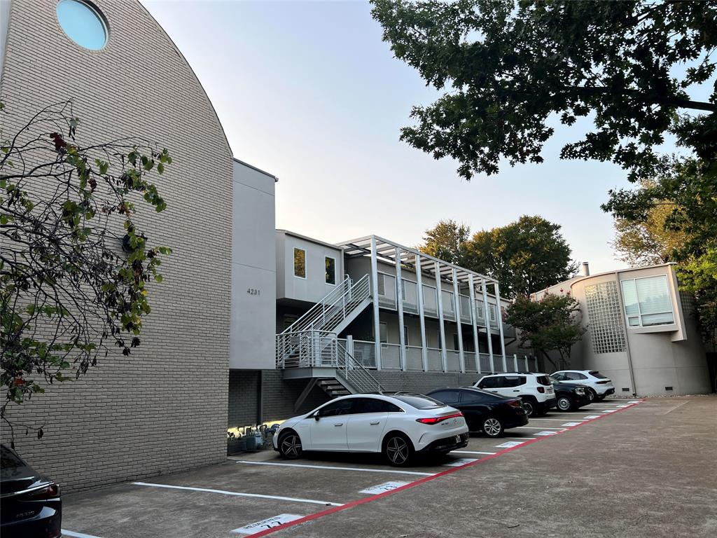 a view of cars parked in front of a house