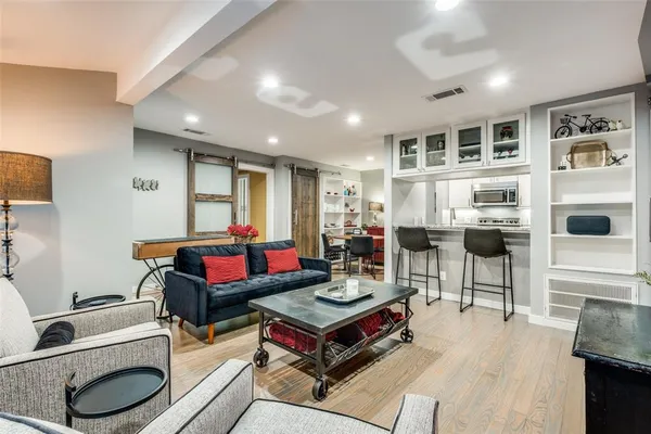 a living room with furniture a rug and a table