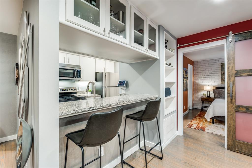 4231 Travis Street, Unit 17 Dallas, TX 75205 - Photo 12 of 26 a kitchen with stainless steel appliances granite countertop a sink and cabinets