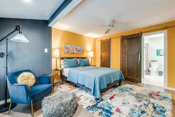 a bedroom with bed and a painting on the wall