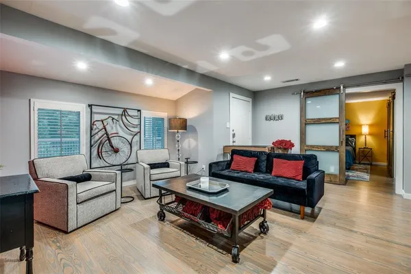 a living room with furniture and wooden floor