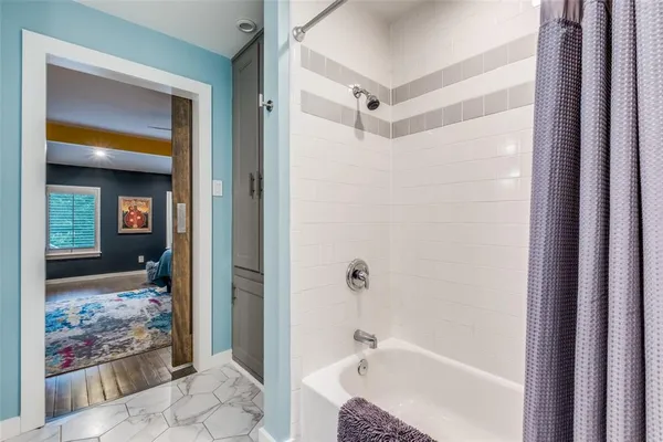 a bathroom with a bathtub and shower