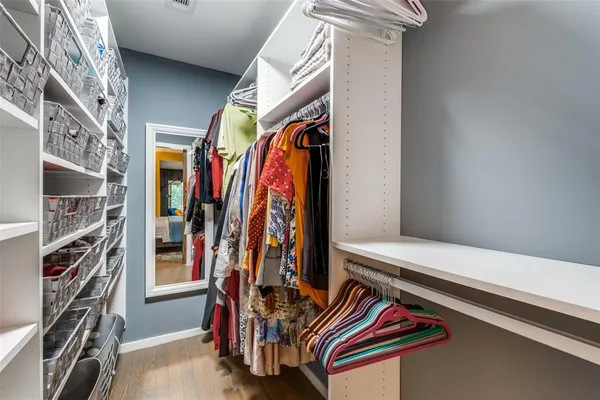 a view of walk in closet with clothes