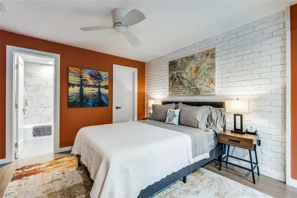 a bedroom with a large bed and a window