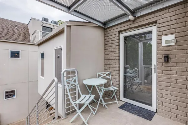 a view of a patio with table and chairs and potted plants