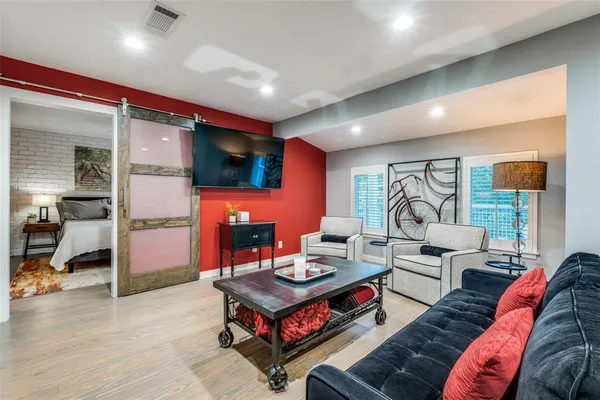 a living room with furniture and a flat screen tv