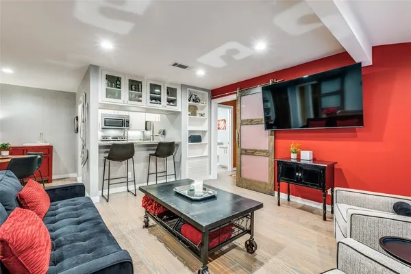a living room with furniture a flat screen tv and a table