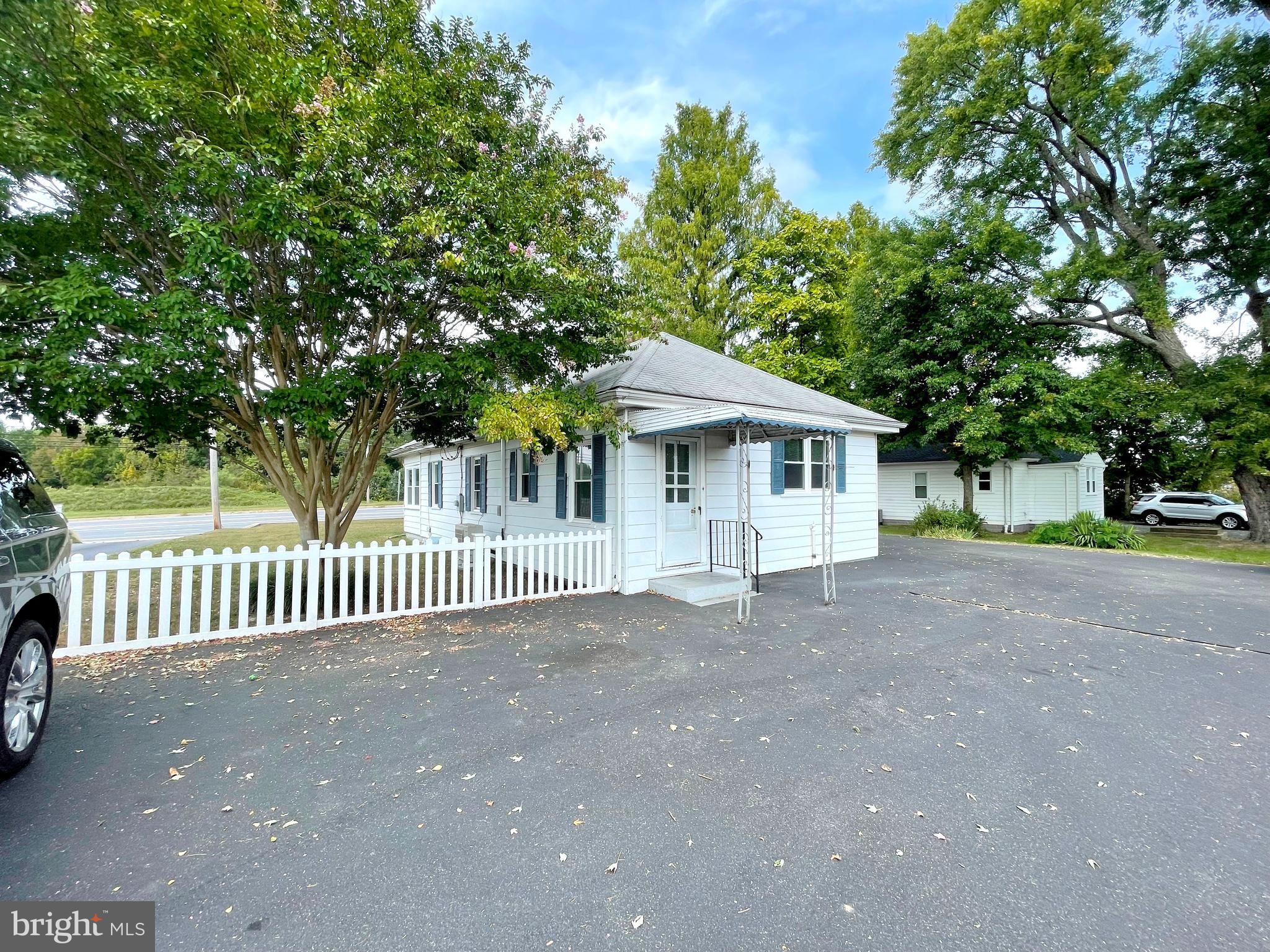 590 Hallowing Point Road Prince Frederick, MD 20678 - Photo 22 of 23 a view of a house with a small yard and a large tree