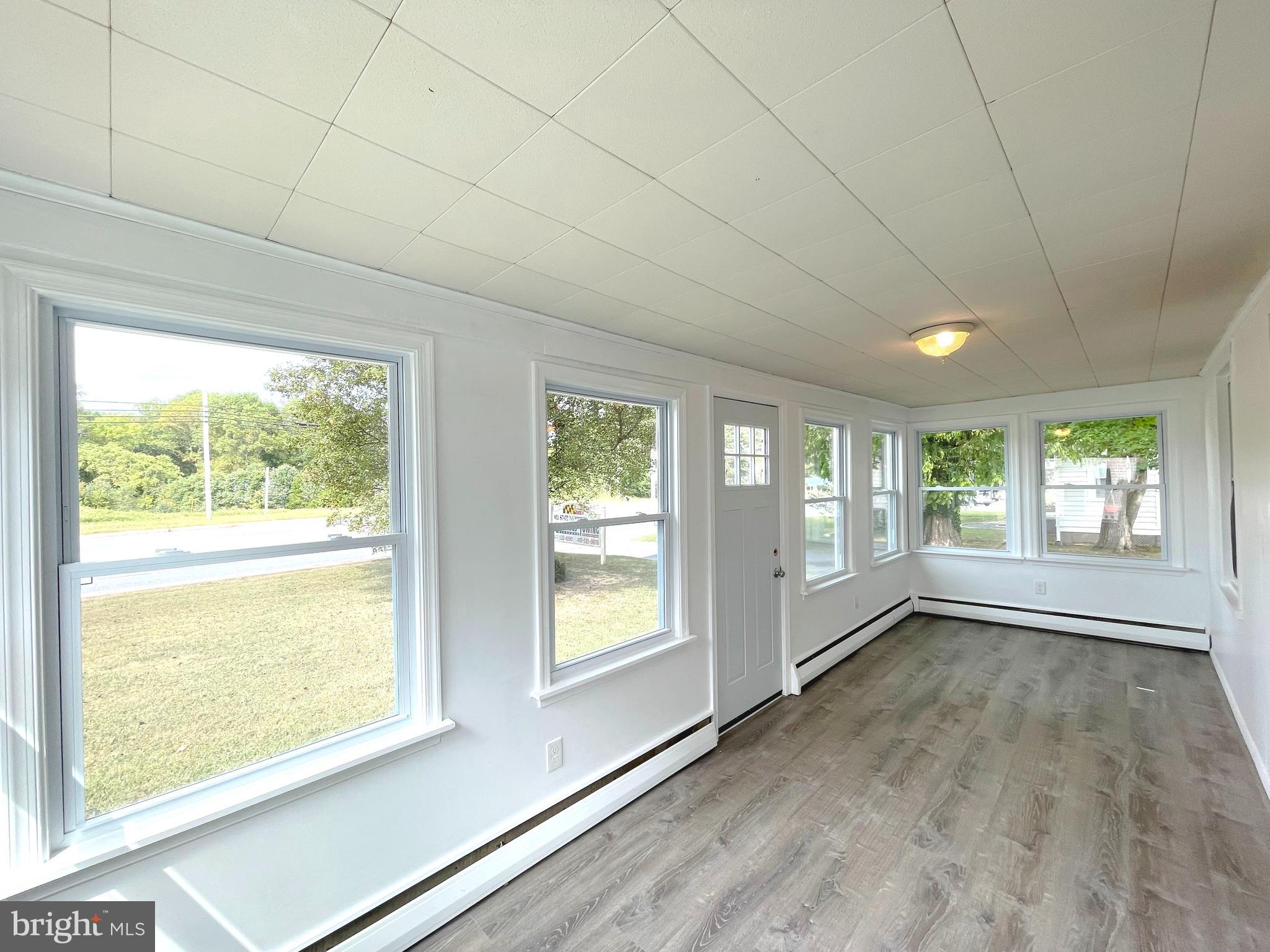 590 Hallowing Point Road Prince Frederick, MD 20678 - Photo 4 of 23 a view of an empty room with a window and wooden floor