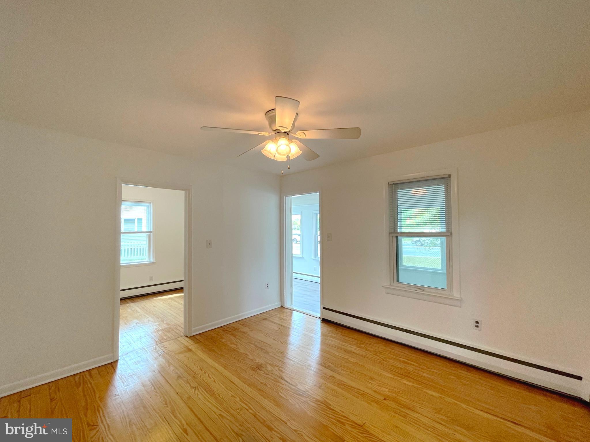 590 Hallowing Point Road Prince Frederick, MD 20678 - Photo 6 of 23 an empty room with wooden floor and windows