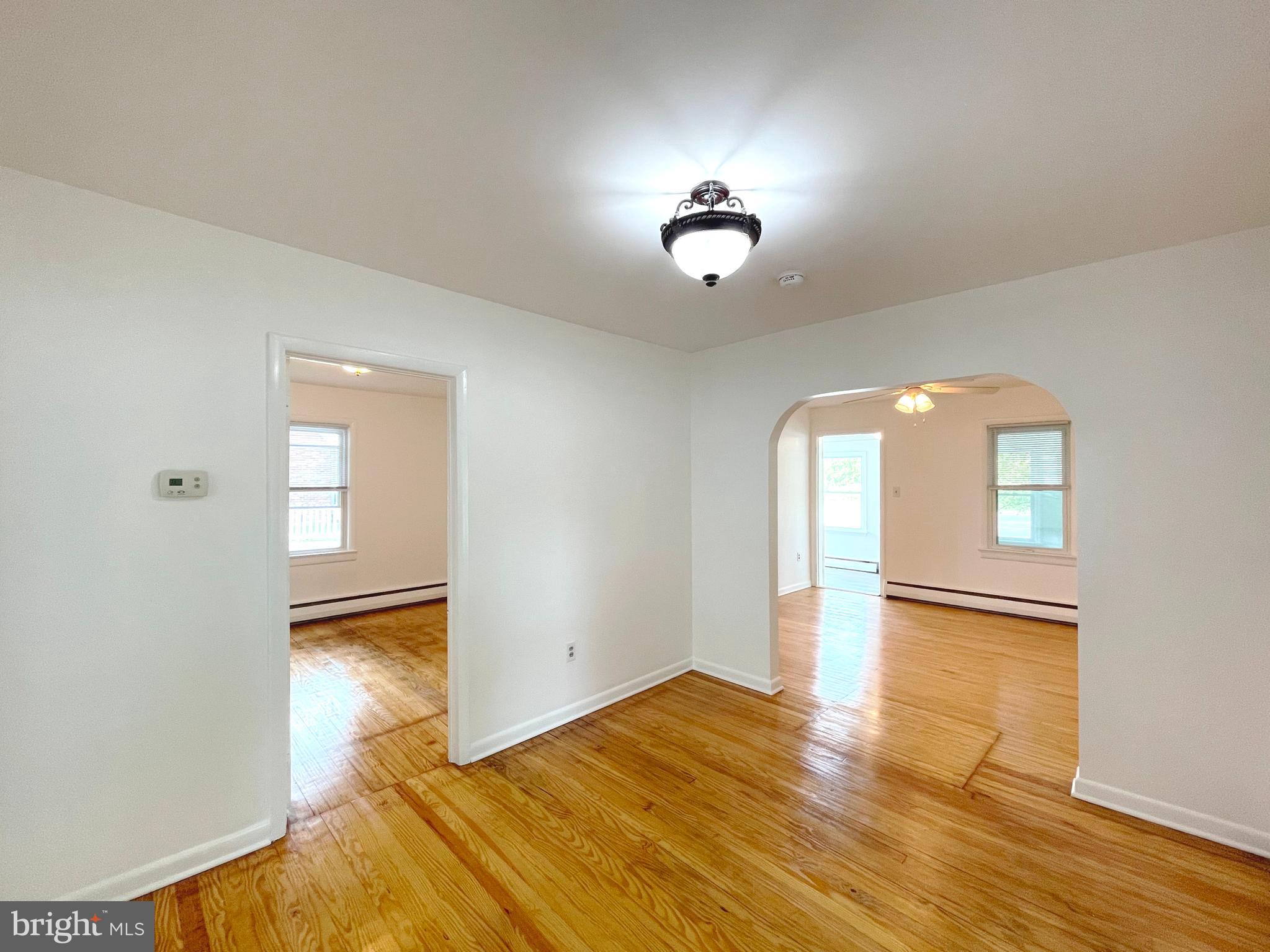 590 Hallowing Point Road Prince Frederick, MD 20678 - Photo 9 of 23 an empty room with wooden floor cabinet and windows