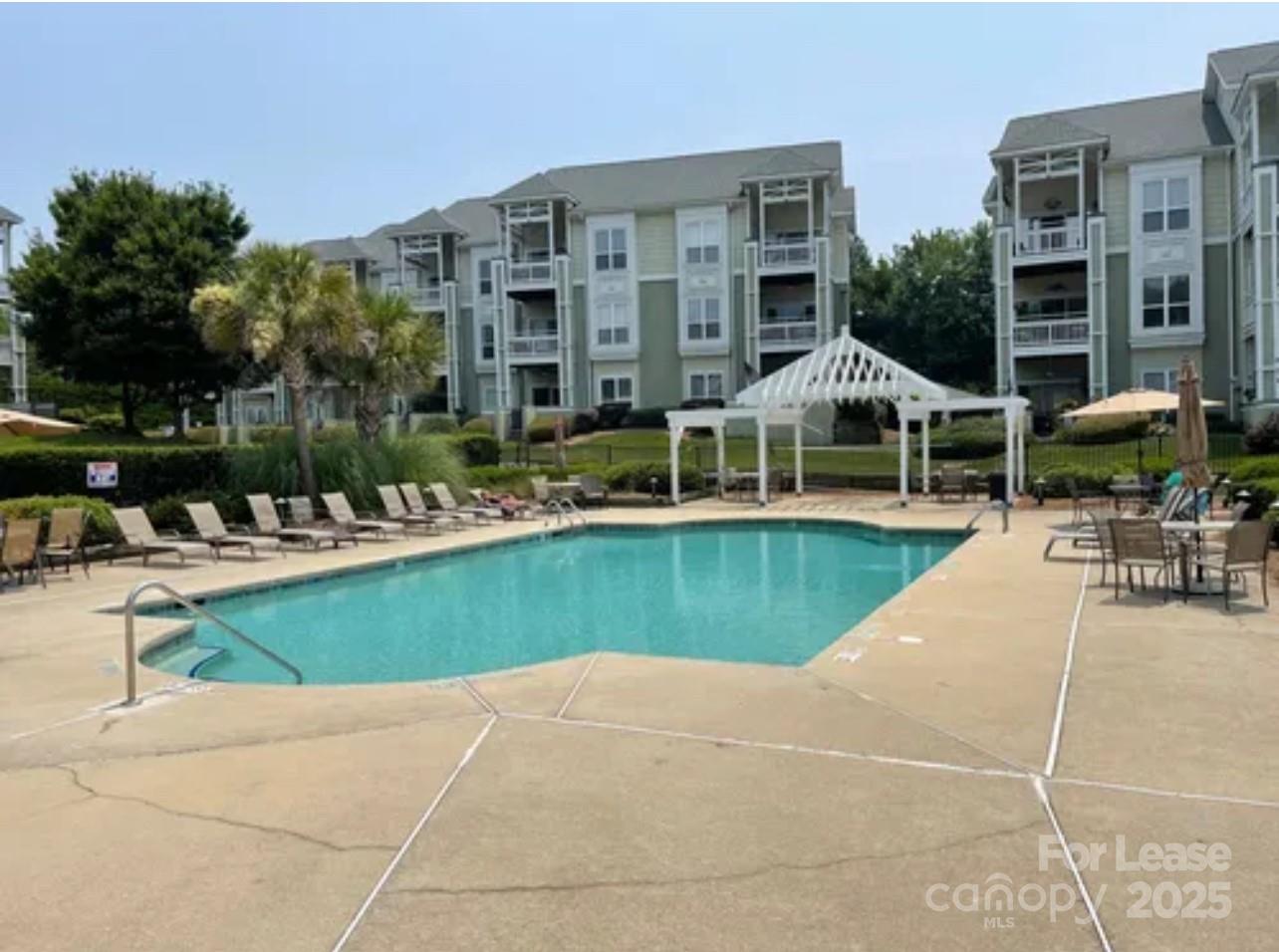 18701 Nautical Drive, Unit 203 Cornelius, NC 28031 - Photo 13 of 13 a view of a swimming pool with outdoor seating