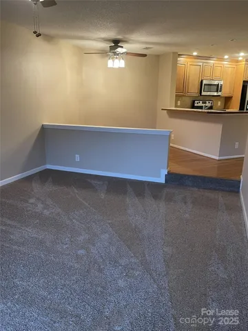 a view of kitchen with refrigerator and microwave