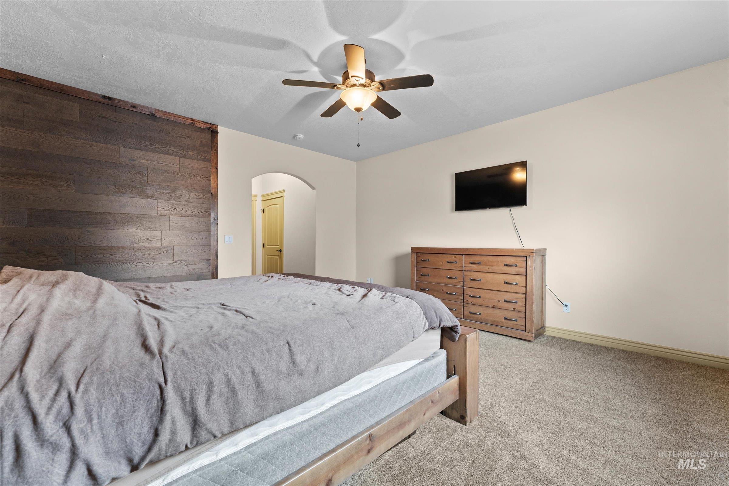 176 East Breinholt Street Meridian, ID 83646 - Photo 14 of 39 Bedroom with carpet, a ceiling fan, and arched walkways