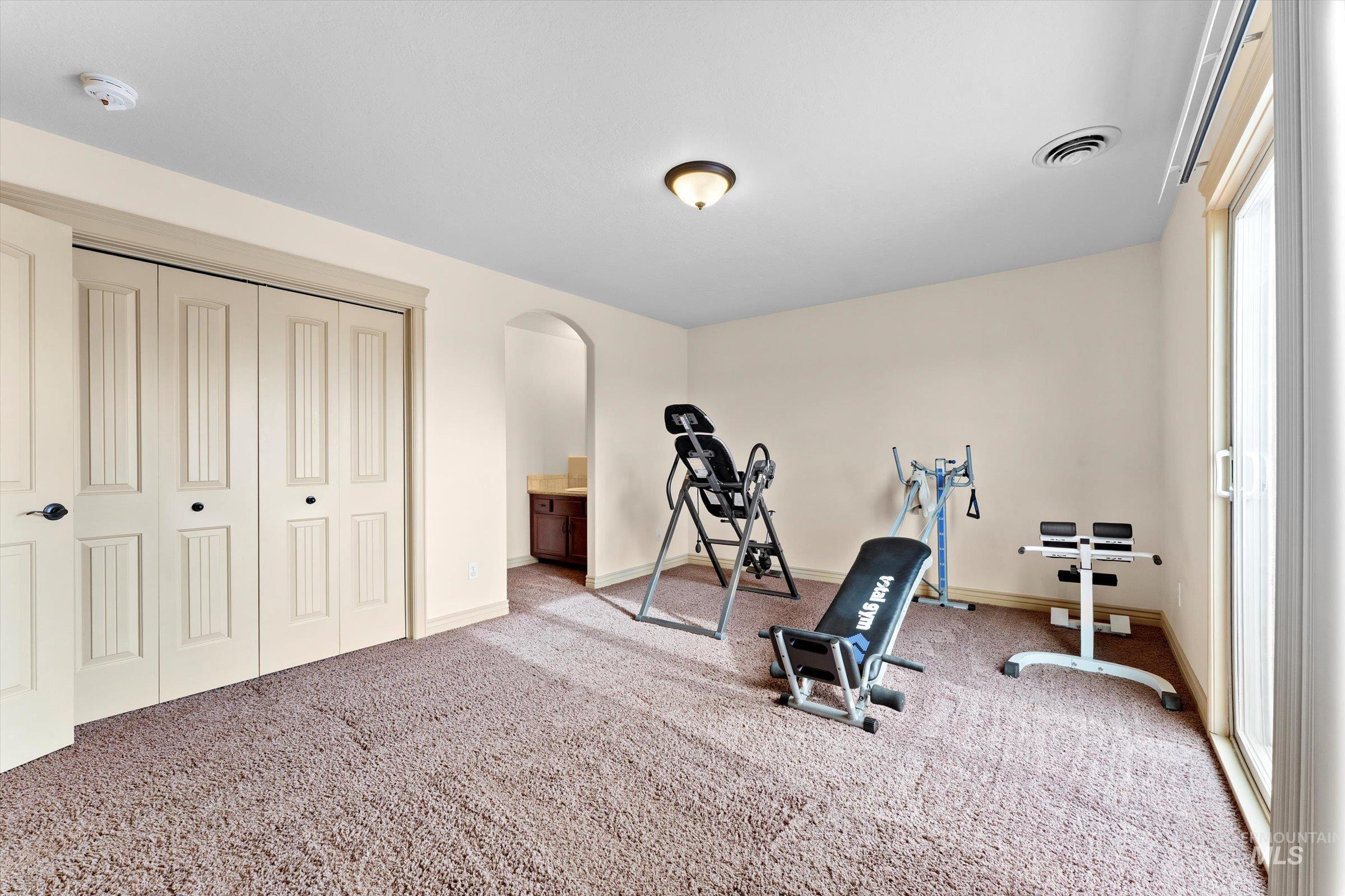 176 East Breinholt Street Meridian, ID 83646 - Photo 18 of 39 Exercise area featuring carpet floors and arched walkways