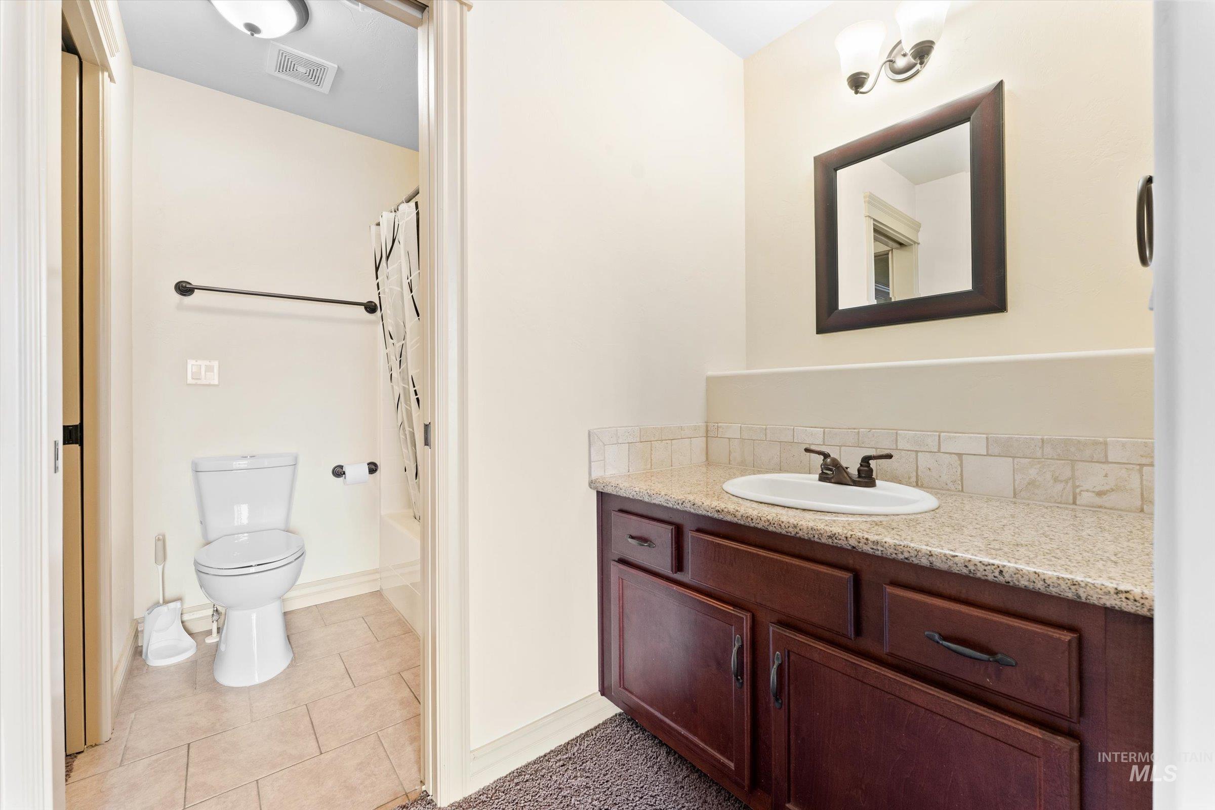 176 East Breinholt Street Meridian, ID 83646 - Photo 20 of 39 Full bathroom featuring vanity, shower / tub combo with curtain, and light tile patterned flooring