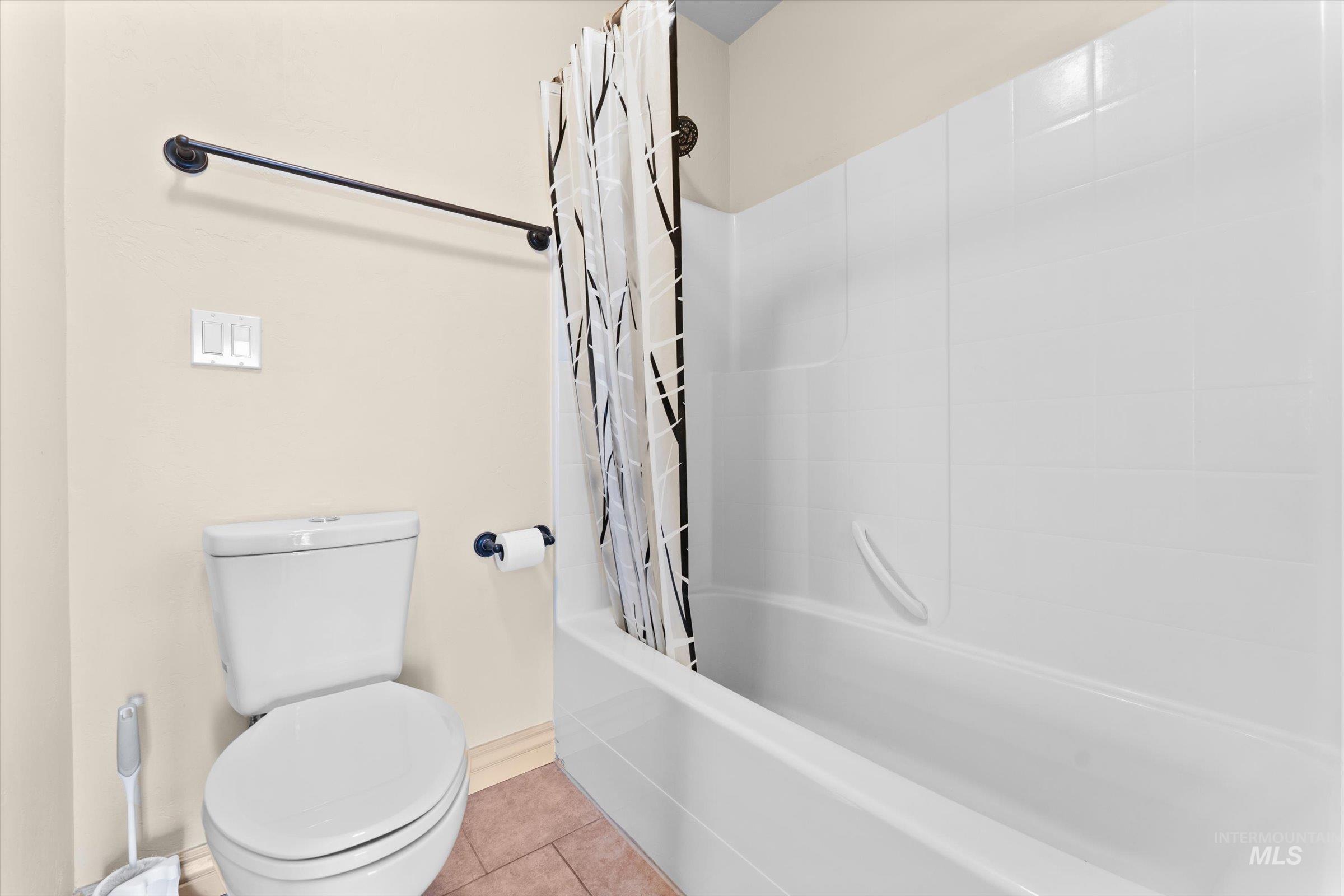 176 East Breinholt Street Meridian, ID 83646 - Photo 21 of 39 Full bath with shower / bathtub combination with curtain and tile patterned floors