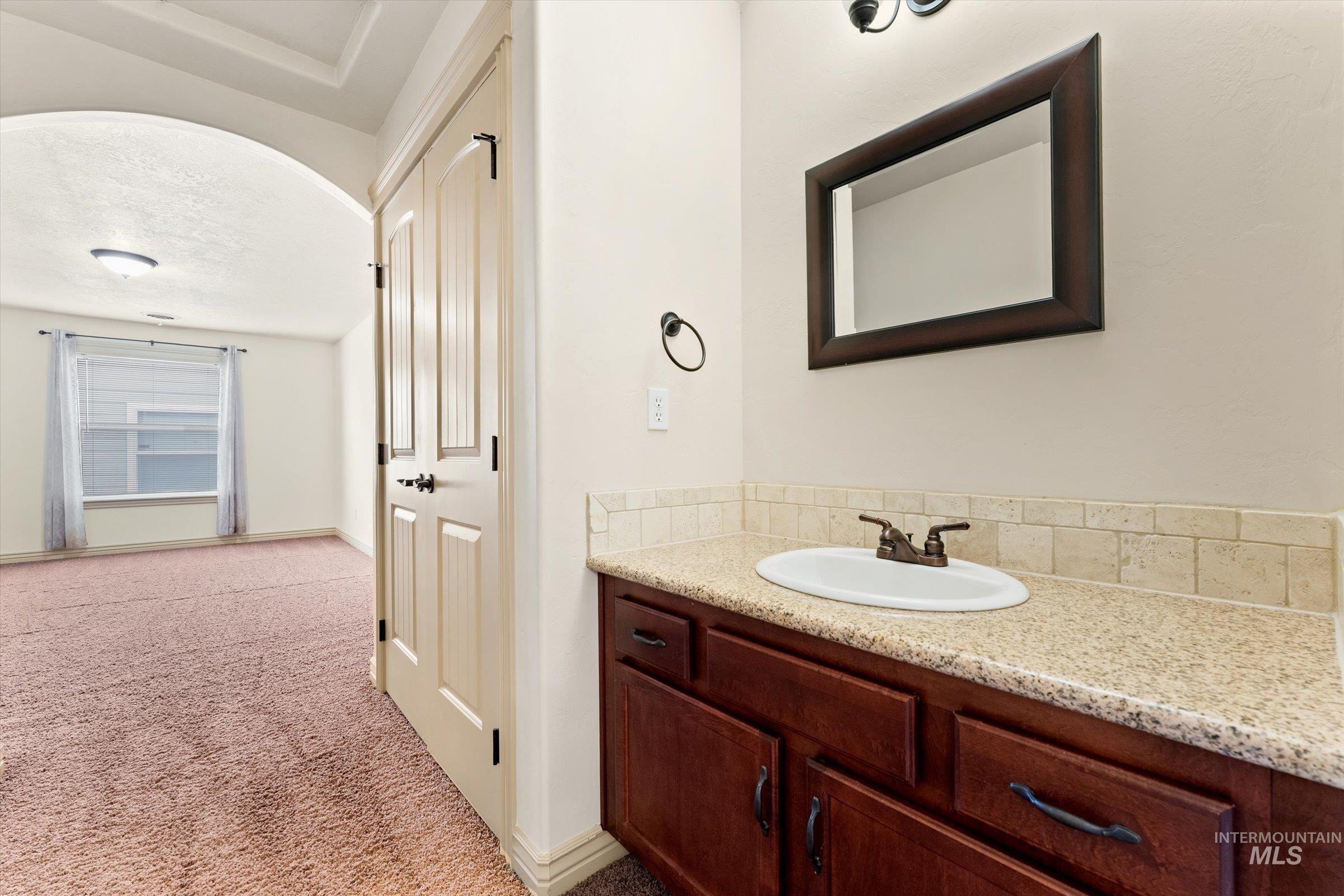 176 East Breinholt Street Meridian, ID 83646 - Photo 22 of 39 Bathroom featuring vanity and light carpet