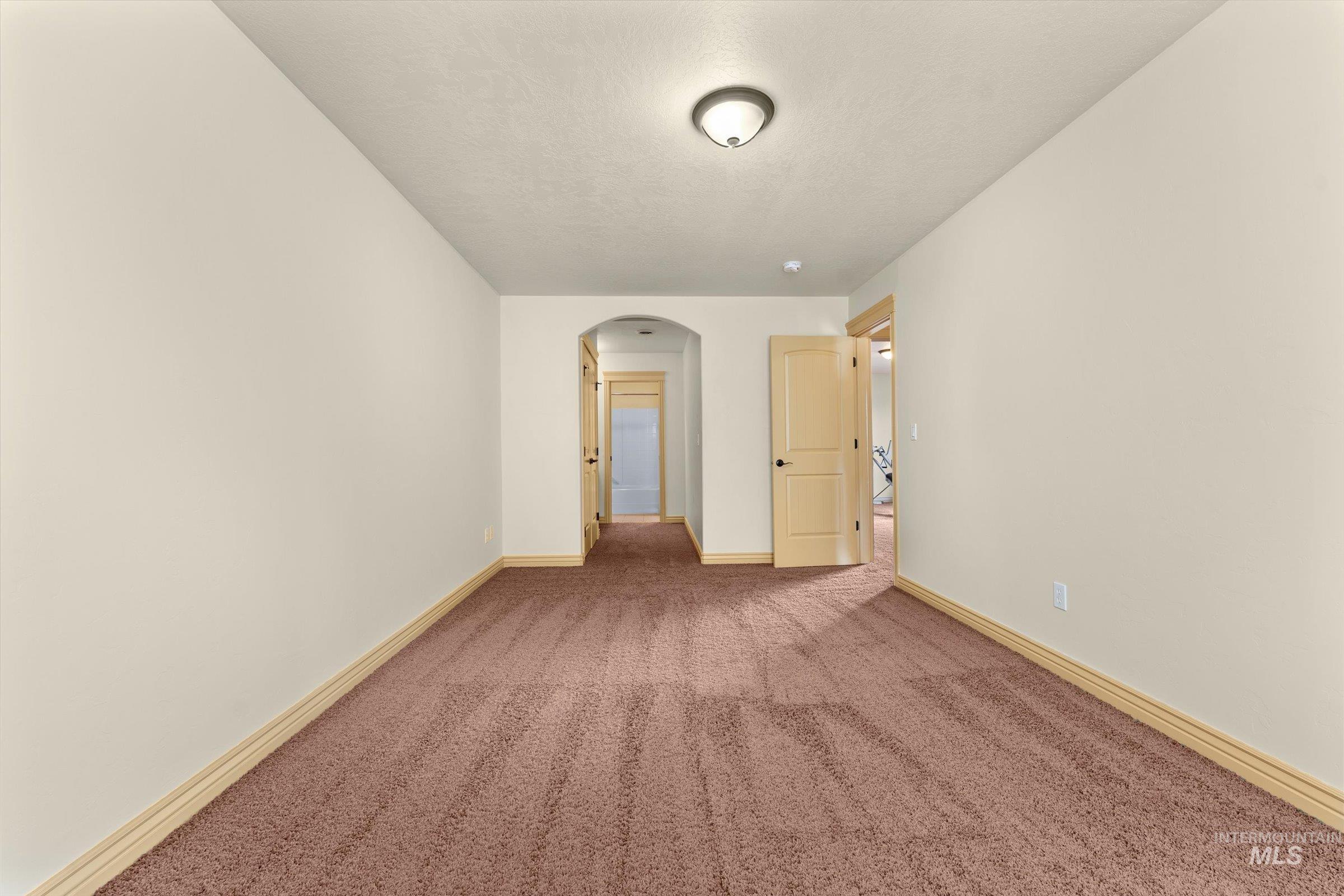 176 East Breinholt Street Meridian, ID 83646 - Photo 23 of 39 Carpeted spare room with arched walkways and baseboards