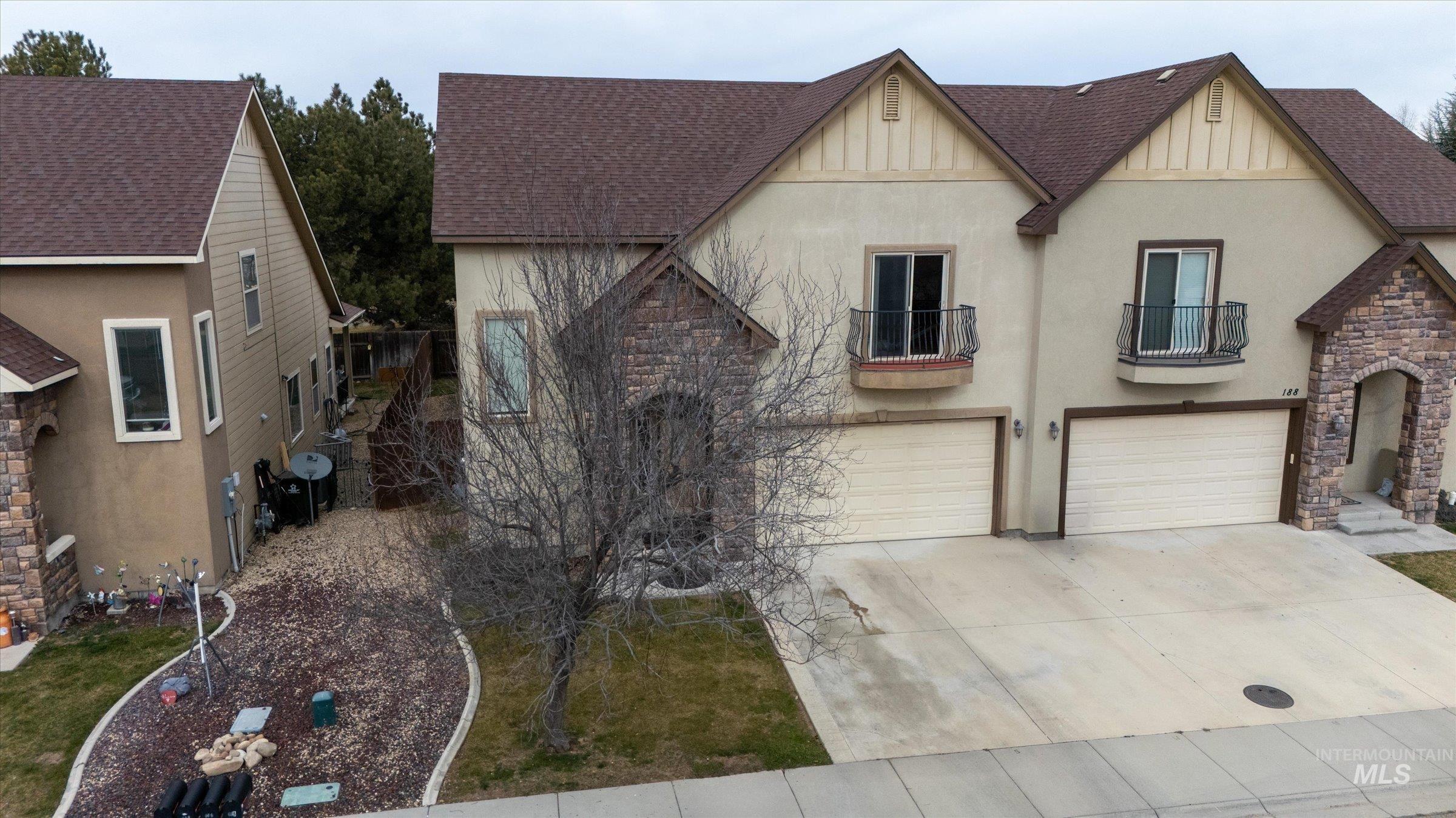 176 East Breinholt Street Meridian, ID 83646 - Photo 36 of 39 View of front facade with a shingled roof, a balcony, and stucco siding