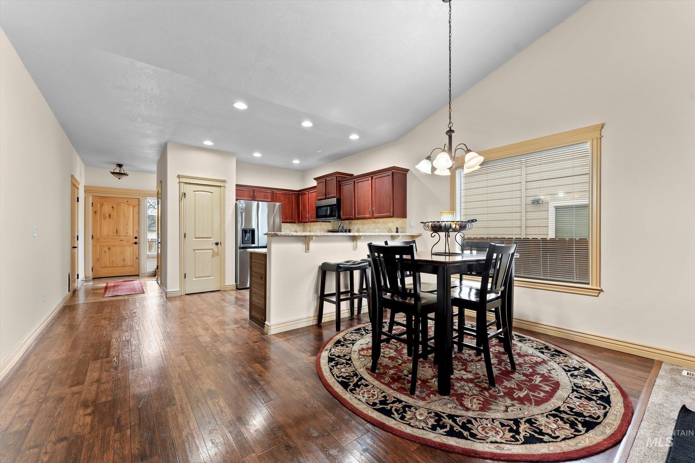 176 East Breinholt Street Meridian, ID 83646 - Photo 8 of 39 Dining area with a chandelier, dark wood-style floors, and recessed lighting