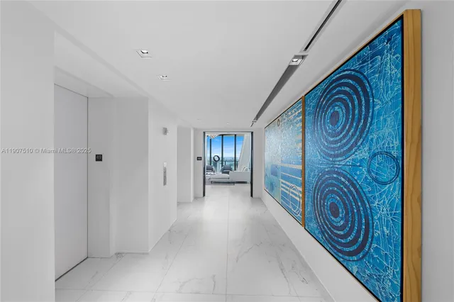 a living room with furniture and floor to ceiling windows