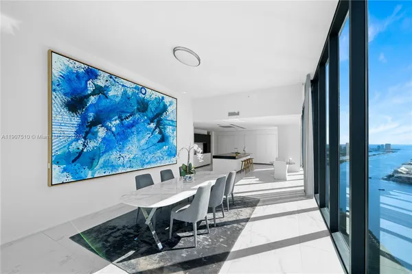 a living room with furniture and a floor to ceiling window