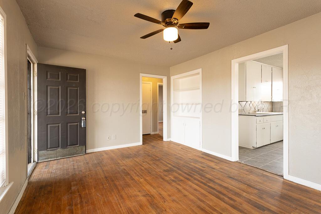 600 South Nelson Street Amarillo, TX 79104 - Photo 3 of 14 a view of empty room with wooden floor and fan