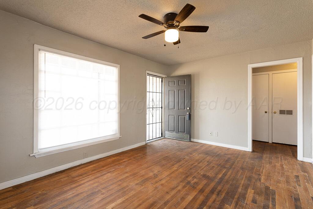 600 South Nelson Street Amarillo, TX 79104 - Photo 4 of 14 a view of an empty room with wooden floor and a window