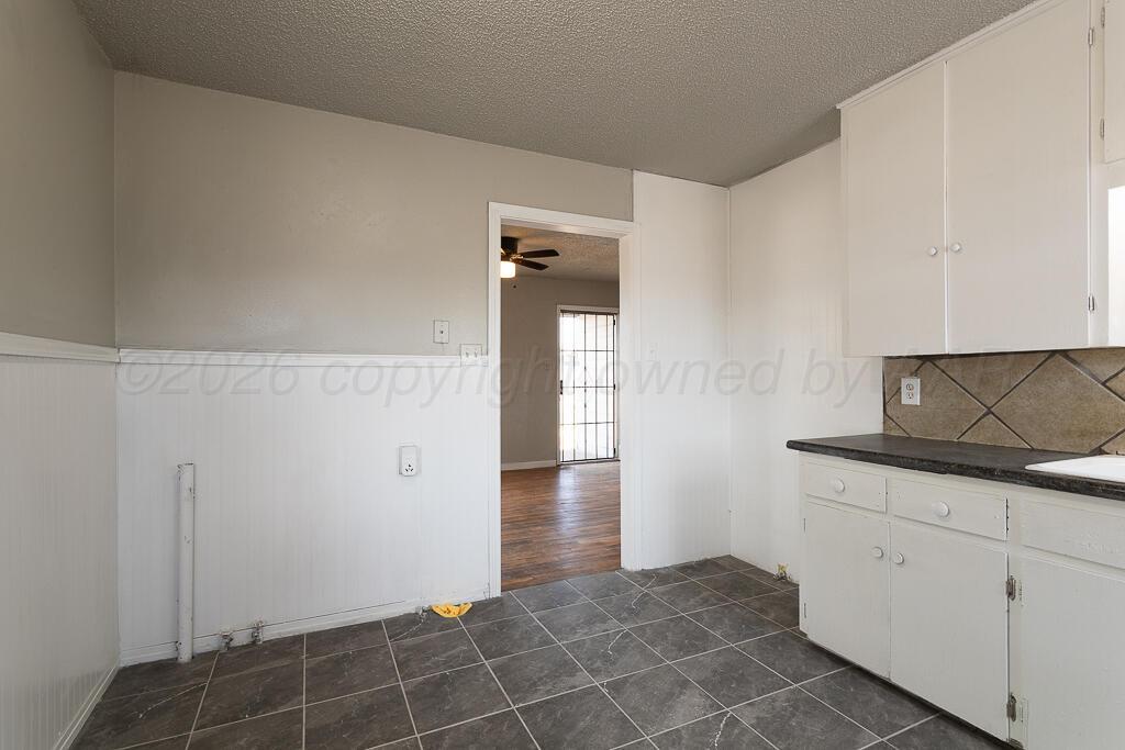 600 South Nelson Street Amarillo, TX 79104 - Photo 6 of 14 a view of hallway with walk in closet and cabinet