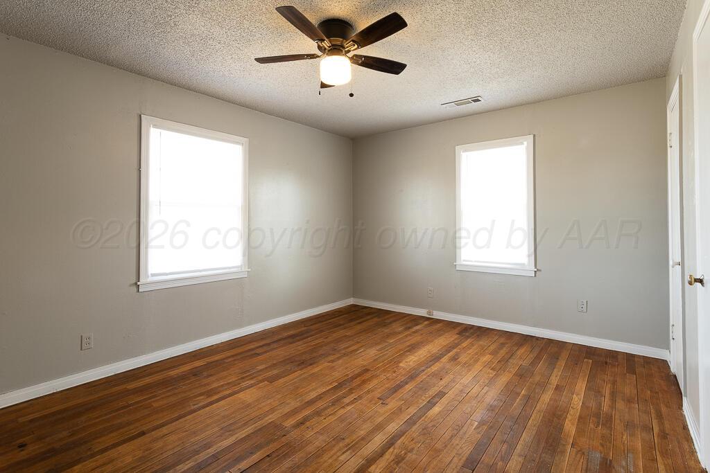 600 South Nelson Street Amarillo, TX 79104 - Photo 7 of 14 a view of empty room with wooden floor and fan