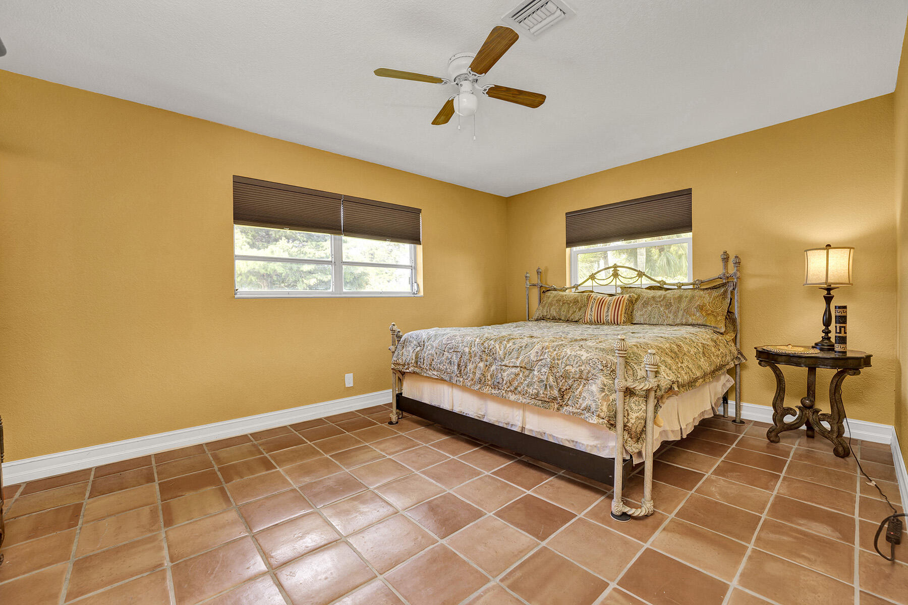 5385 Adams Road Delray Beach, FL 33484 - Photo 13 of 46 a bedroom with a bed and a table in it