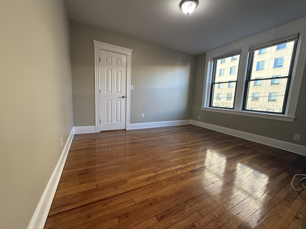 660 Huntington Avenue, Unit 23 Boston, MA 02115 - Photo 3 of 23 an empty room with wooden floor and windows