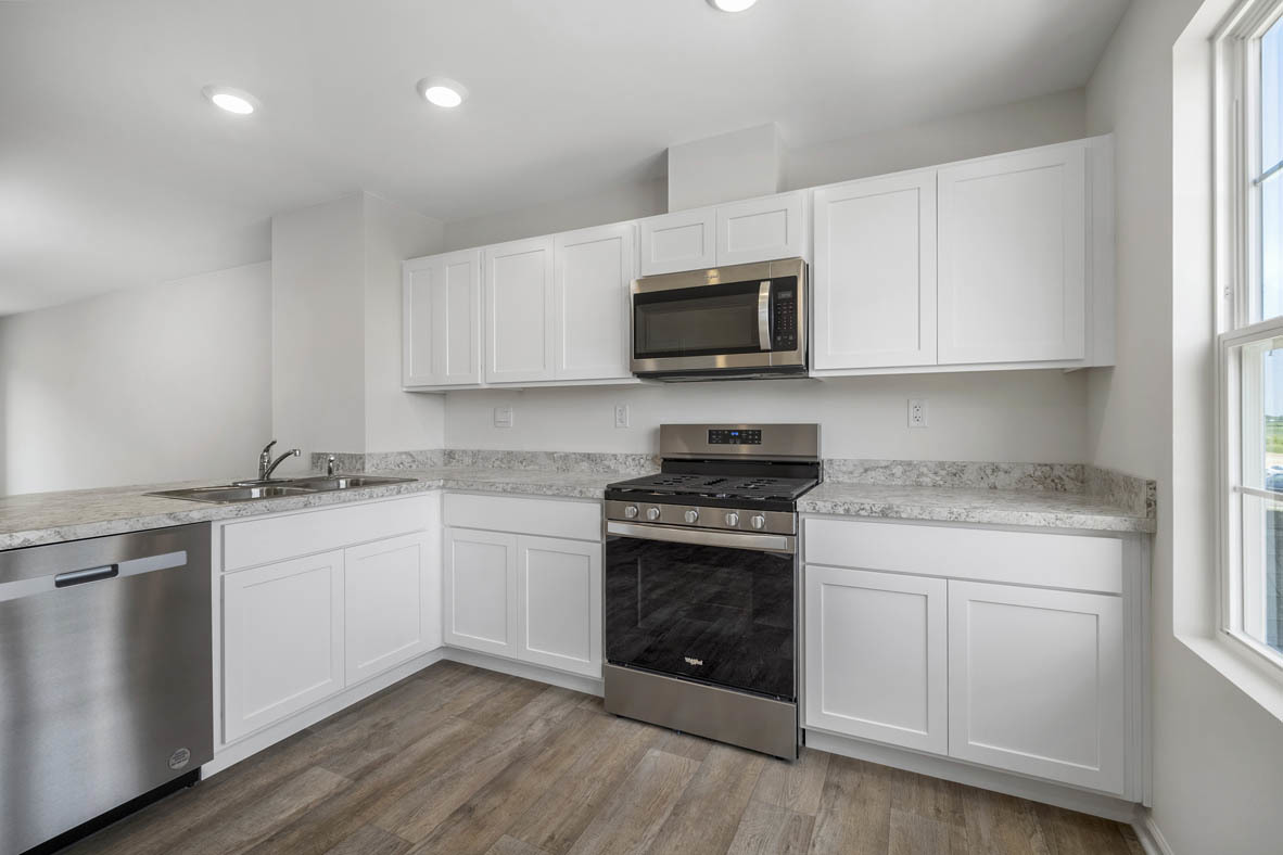 1478 Yosemite Way Pingree Grove, IL 60140 - Photo 11 of 18 a kitchen with granite countertop white cabinets and stainless steel appliances