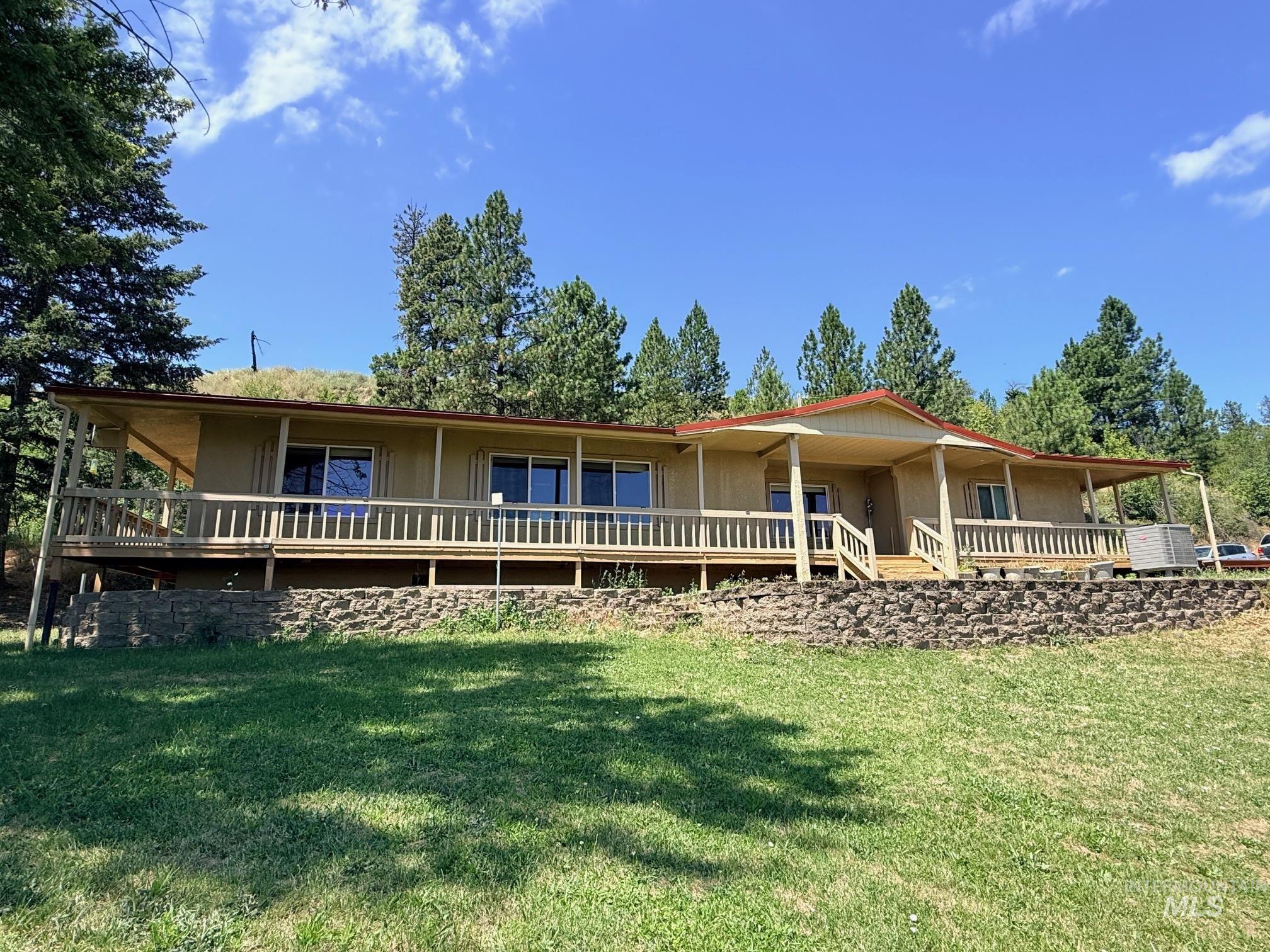 35322 River Road Lenore, ID 83541 - Photo 39 of 42 Expansive front deck featuring wood railings and a covered entry