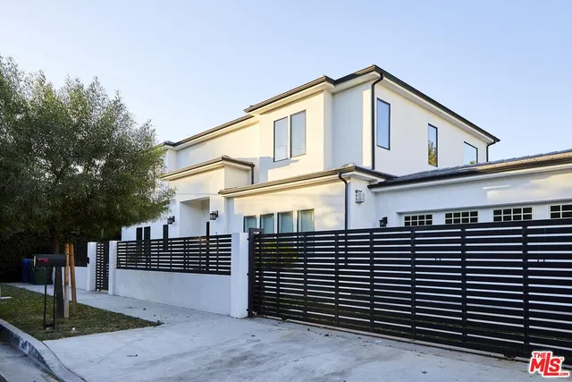 a front view of a house with a street