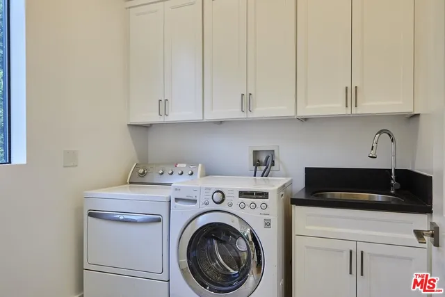 a view of cabinets and washer dryer
