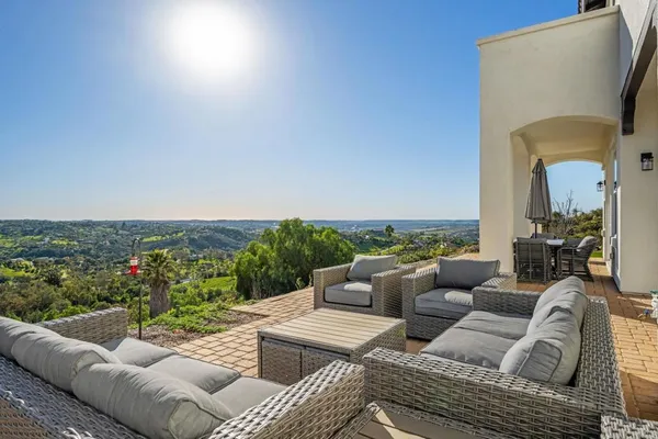 a view of a patio with couches chairs and a potted plant