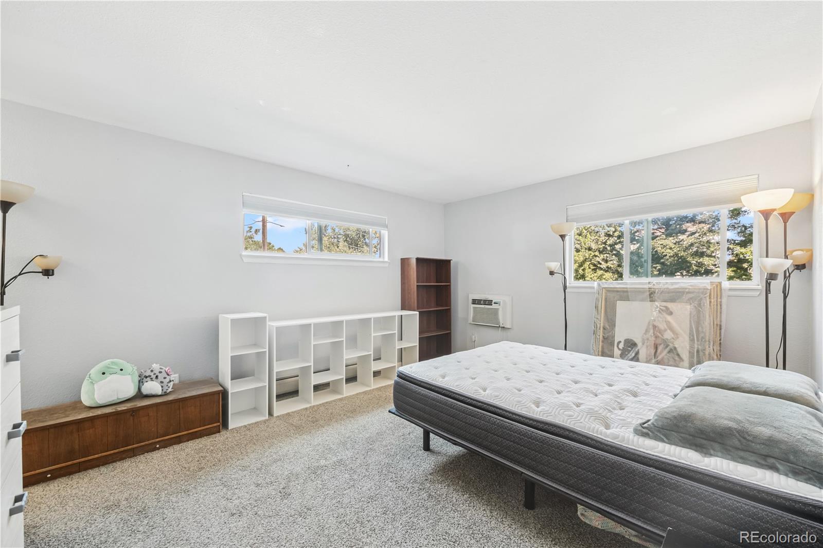 7740 West 35th Avenue, Unit 214 Wheat Ridge, CO 80033 - Photo 11 of 20 a bedroom with a bed and a window